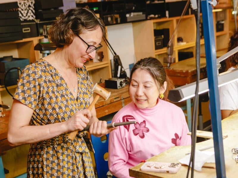 two women at a silver ring making workshop